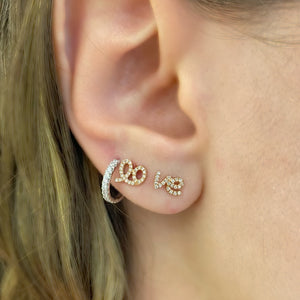 Female model wearing Diamond Love Script Stud Earrings - 14K gold weighing 1.16 grams - 48 round diamonds totaling 0.10 carats