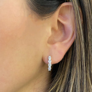 Female Model Wearing Diamond Cluster Hoop Earrings - 18K gold weighing 3.17 grams  - 26 round diamonds weighing 0.78 carats