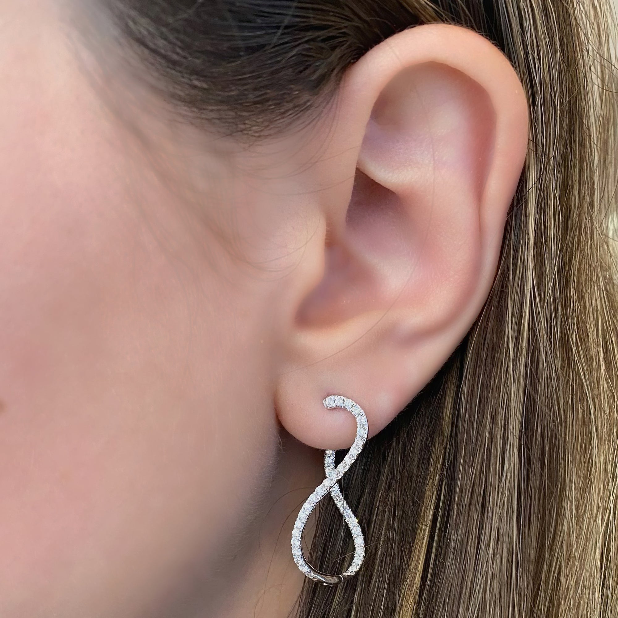 Diamond infinity hoop earrings - 18K gold weighing 4.34 grams  - 78 round diamonds totaling 0.73 carats