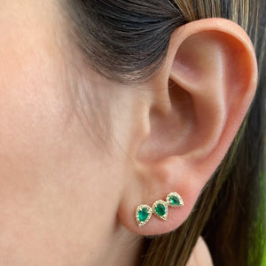 Female model wearing Green Emerald Pear-Shaped Diamond Ear Climbers-14K gold weighing 2.25 grams  -86 round diamonds weighing 0.20 carats  -6 emeralds weighing 0.53 carats