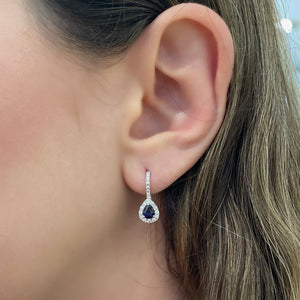 Female Model Wearing Sapphire & Diamond Teardrop Lever-Back Earrings  - 18K gold weighing 2.48 grams  - 2 sapphires totaling 0.71 carats  - 38 round diamonds totaling 0.40 carats