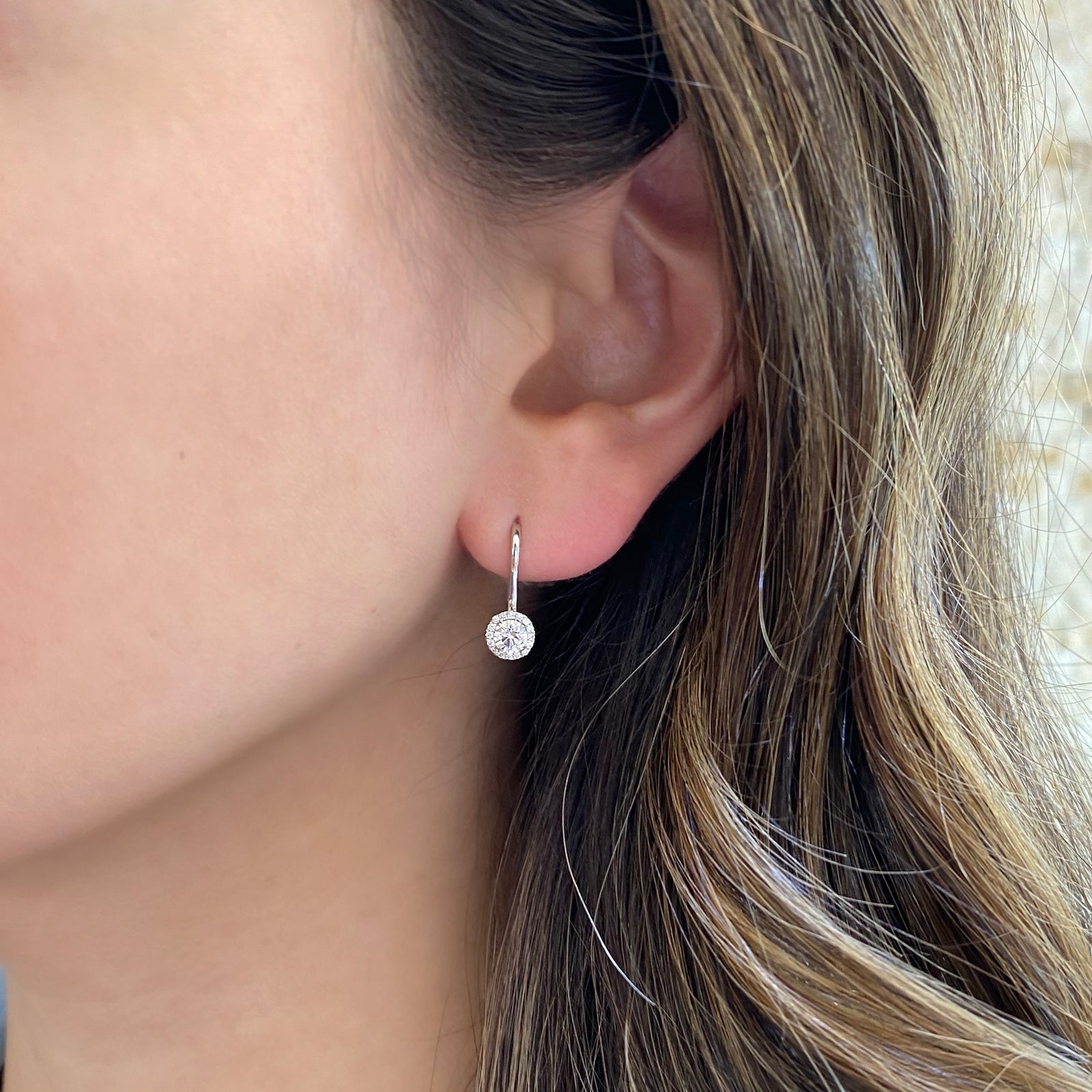 Diamond Halo Lever-Back Earrings  - 18K gold weighing 2.19 grams  - 32 round diamonds totaling 0.11 carats  - 2 round diamonds totaling 0.46 carats