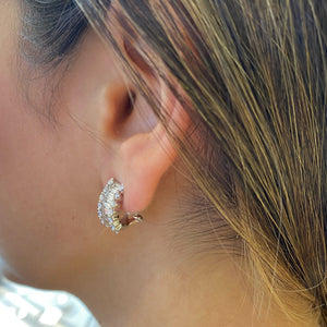 Female model wearing Baguette & Round Diamond Half Hoop Earrings - 18K yellow gold weighing 6.87 grams - 28 round diamonds weighing 0.96 carats - 20 baguette diamonds weighing 1.04 carats