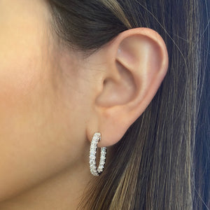 Female model wearing 3 ct diamond interior & exterior hoop earrings - 18K gold weighing 9.50 grams  - 38 round diamonds totaling 3.06 carats