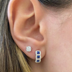 Female model wearing Sapphire & Diamond huggie earrings - 18K gold weighing 4.04 grams  - 56 round diamonds totaling 0.30 carats  - 6 sapphires totaling 0.50 carats