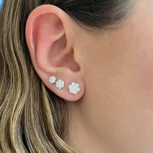 Female model wearing 0.33 ct Diamond Cluster Stud Earrings - 18K yellow gold weighing 1.07 grams - 14 round diamonds weighing 0.33 carats