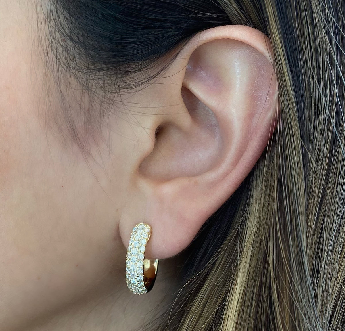 Female Model Wearing Pave Diamond Chubby Huggie Earrings - 14K gold weighing 6.65 grams  - 66 round diamonds totaling 1.78 carats