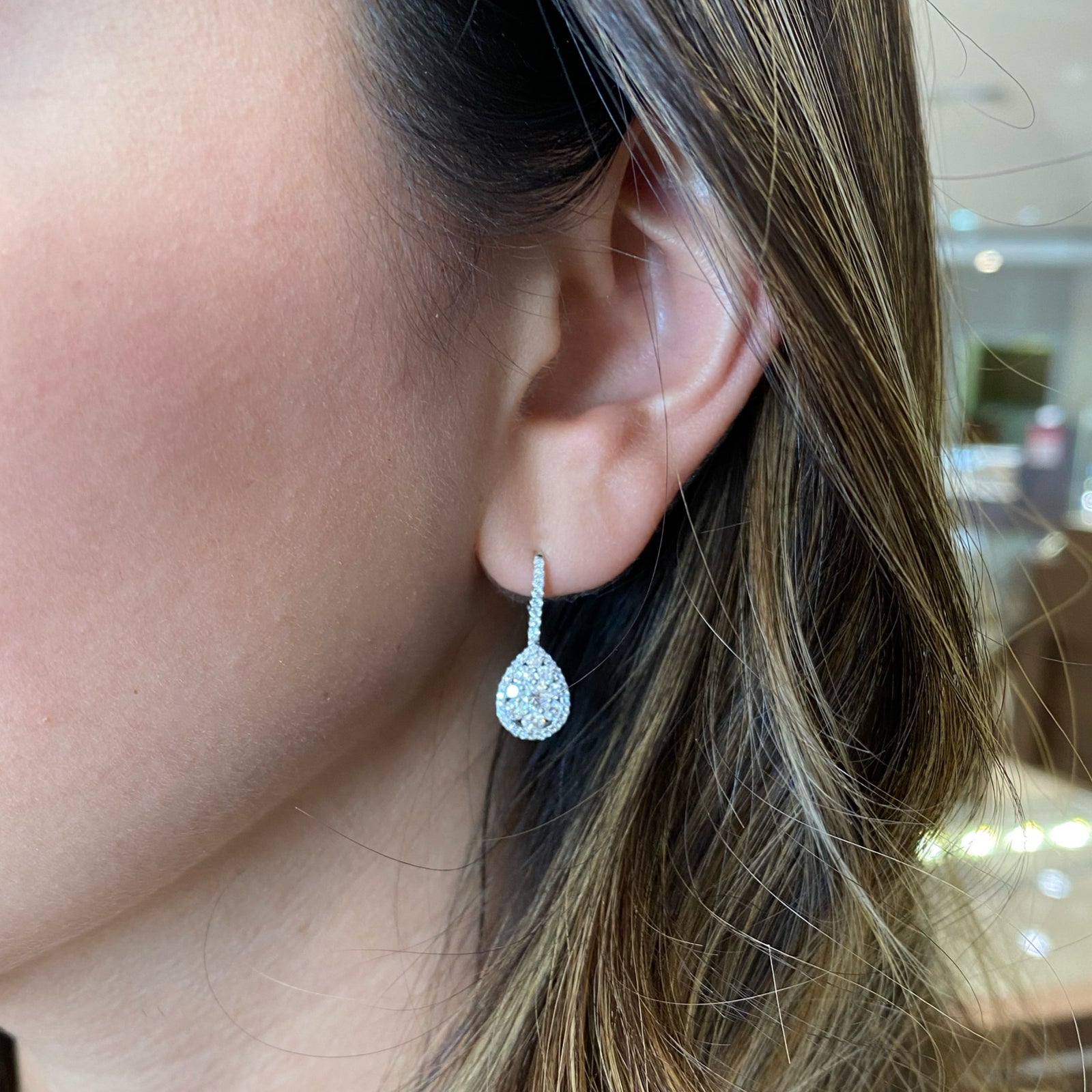 Diamond Teardrop Lever-Back Earrings - 18K gold weighing 3.27 grams  - 2 round diamonds weighing 0.28 carats  - 88 round diamonds weighing 1.0 carats