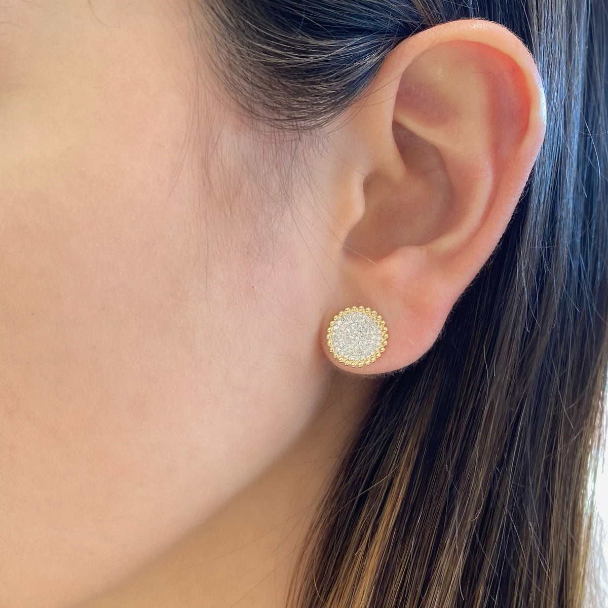 Female model wearing Diamond Button Stud Earrings with Beaded Gold - 14K gold weighing 1.65 grams - 126 round diamonds totaling 0.33 carats