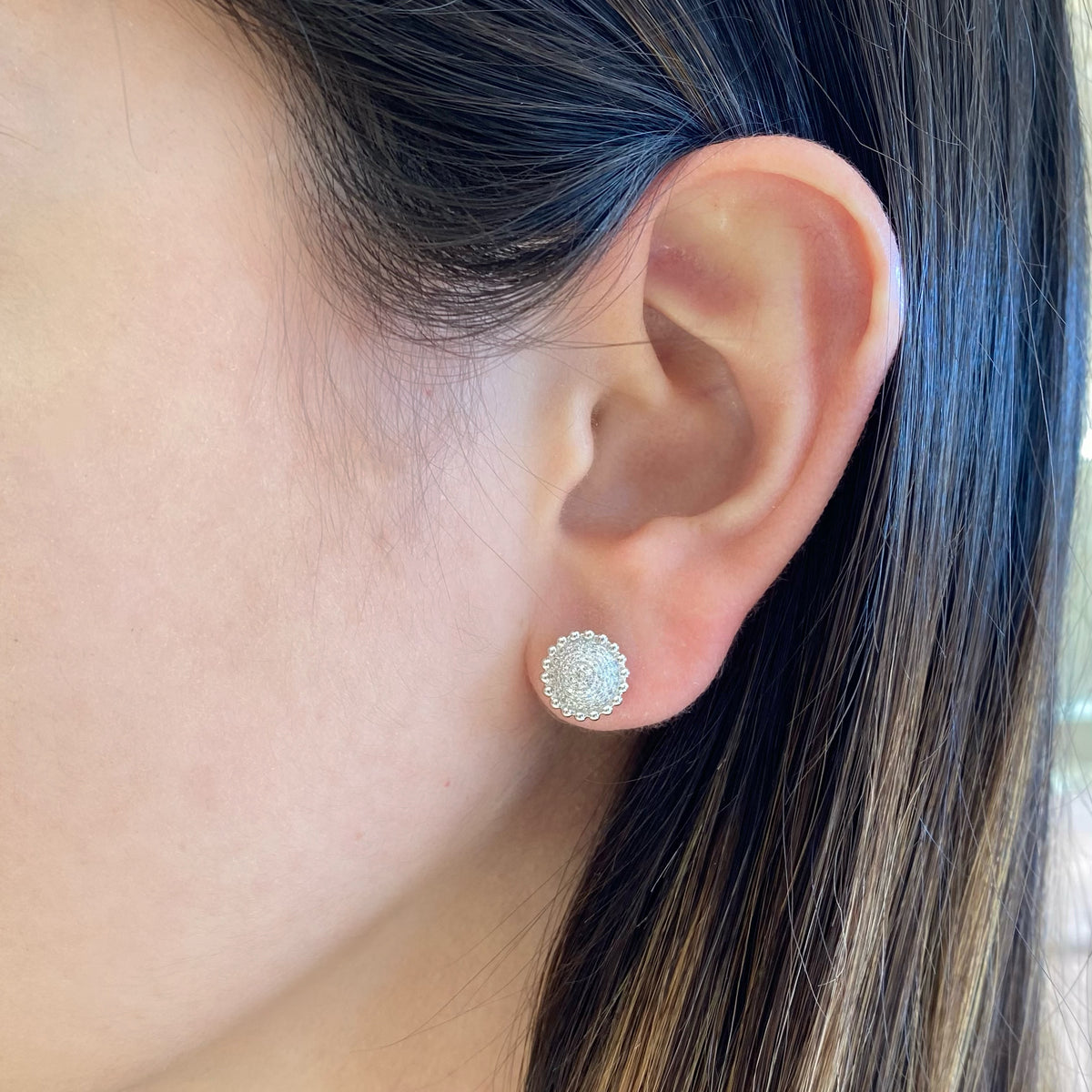 Female model wearing Diamond Layered Circle Stud Earrings with Beaded Gold - 14K gold weighing 2.25 grams - 116 round diamonds totaling 0.27 carats