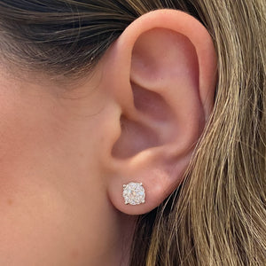 female model wearing 0.78 ct diamond cluster earrings - 18K gold weighing 1.69 grams  - 2 round diamonds totaling 0.38 carats  - 18 round diamonds totaling 0.40 carats