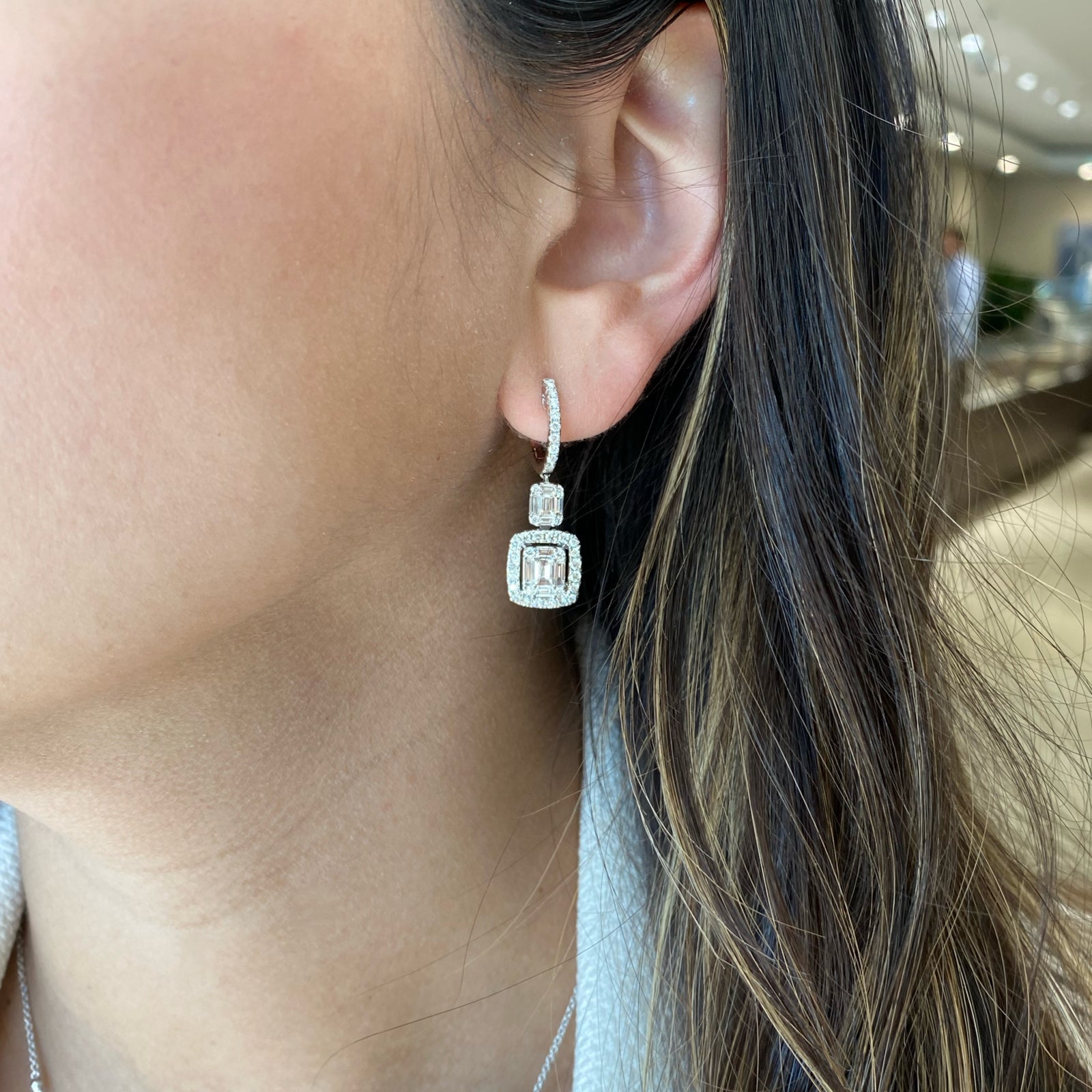 Emerald-Cut Diamond Illusion Dangle Earrings - 18K gold weighing 5.93 grams  - 20 slim baguettes weighing 1.03 carats  - 74 round diamonds weighing 0.93 carats