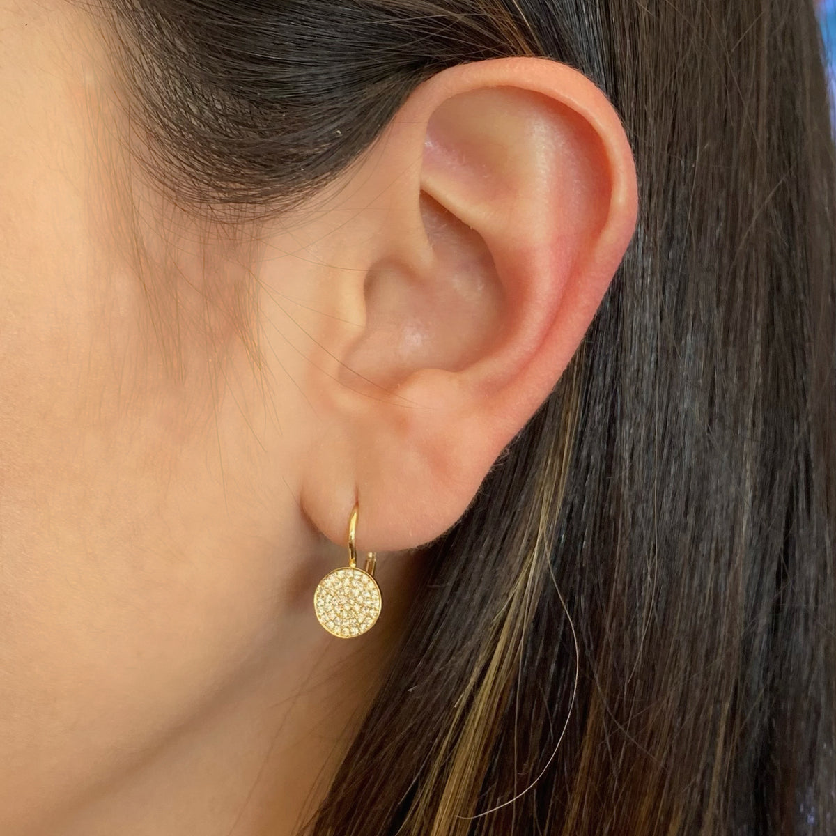 Female model wearing Pave Diamond Disc Earrings  -14K yellow gold weighing 1.79 grams  -94 round diamonds weighing 0.37 carats