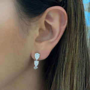Female Model Wearing Diamond Teardrops Hoops Earrings - 18K gold weighing 6.47 grams  - 54 round diamonds totaling 1.22 carats