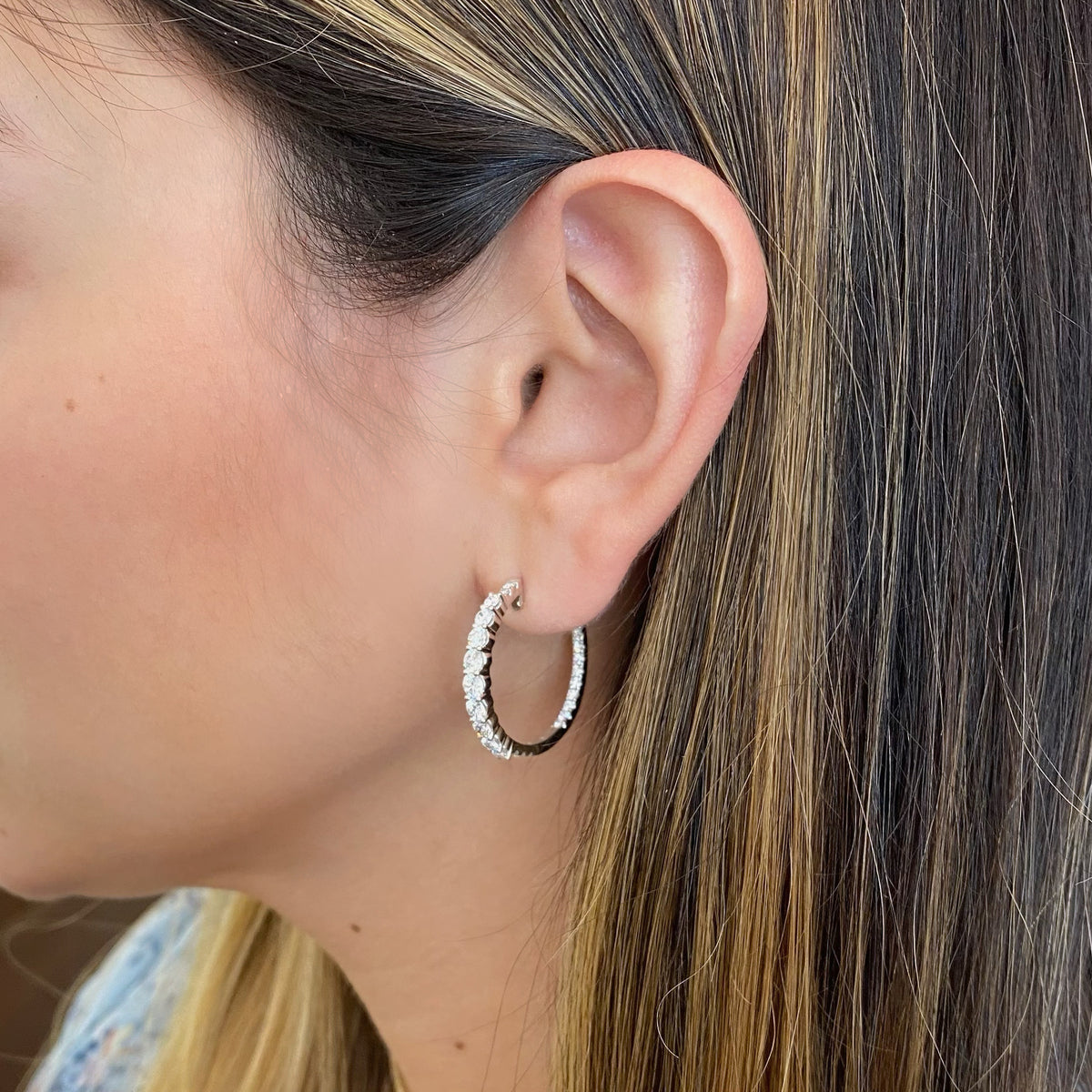Female Model Wearing Diamond Interior and Exterior Hoop Earrings - 18K gold weighing 6.00 grams  - 56 round diamonds totaling 1.99 carats