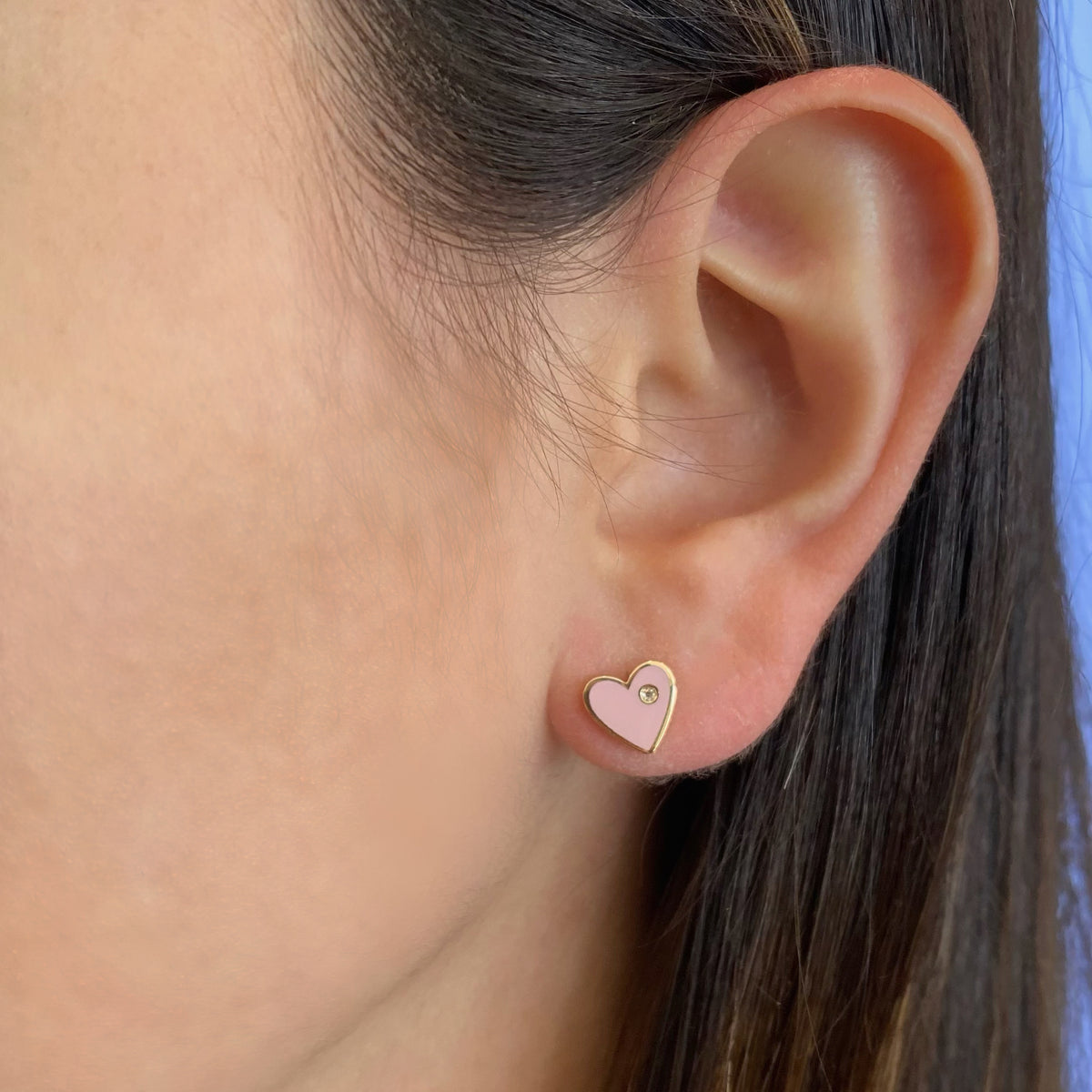 Female model wearing Diamond & enamel heart stud earrings - 14K gold weighing 1.36 grams  - 2 round diamonds totaling 0.01 carats