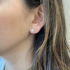 Female model wearing Clover Diamond Stud Earrings -Platinum weighing 2.6 grams -8 round bezel-set diamonds weighing .45 carats