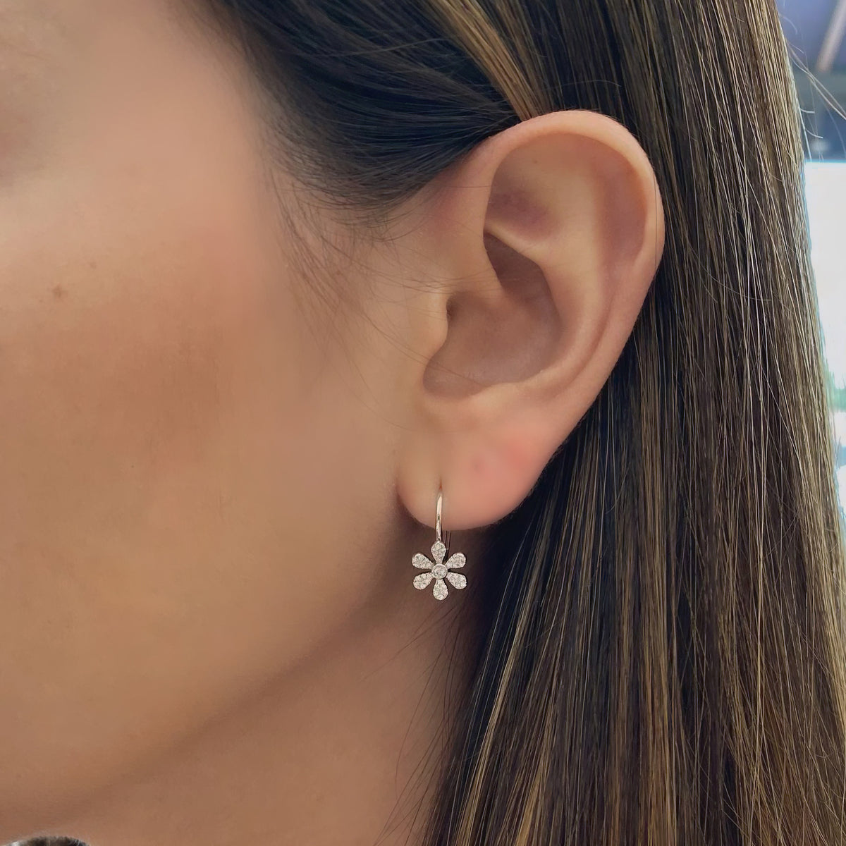 Female Model Wearing Diamond Flower Lever-Back Earrings  -14K gold weighing 1.85 grams  -74 round pave-set diamonds totaling 0.23 carats