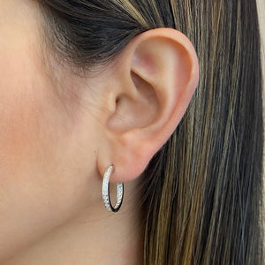 Female model wearing Diamond Interior-Exterior Hoop Earrings with Milgrain - 18K gold weighing 5.09 grams - 42 round diamonds totaling 0.60 carats