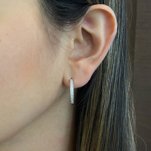 Female model wearing Diamond Interior-Exterior Hoop Earrings with Milgrain - 18K gold weighing 5.09 grams - 42 round diamonds totaling 0.60 carats