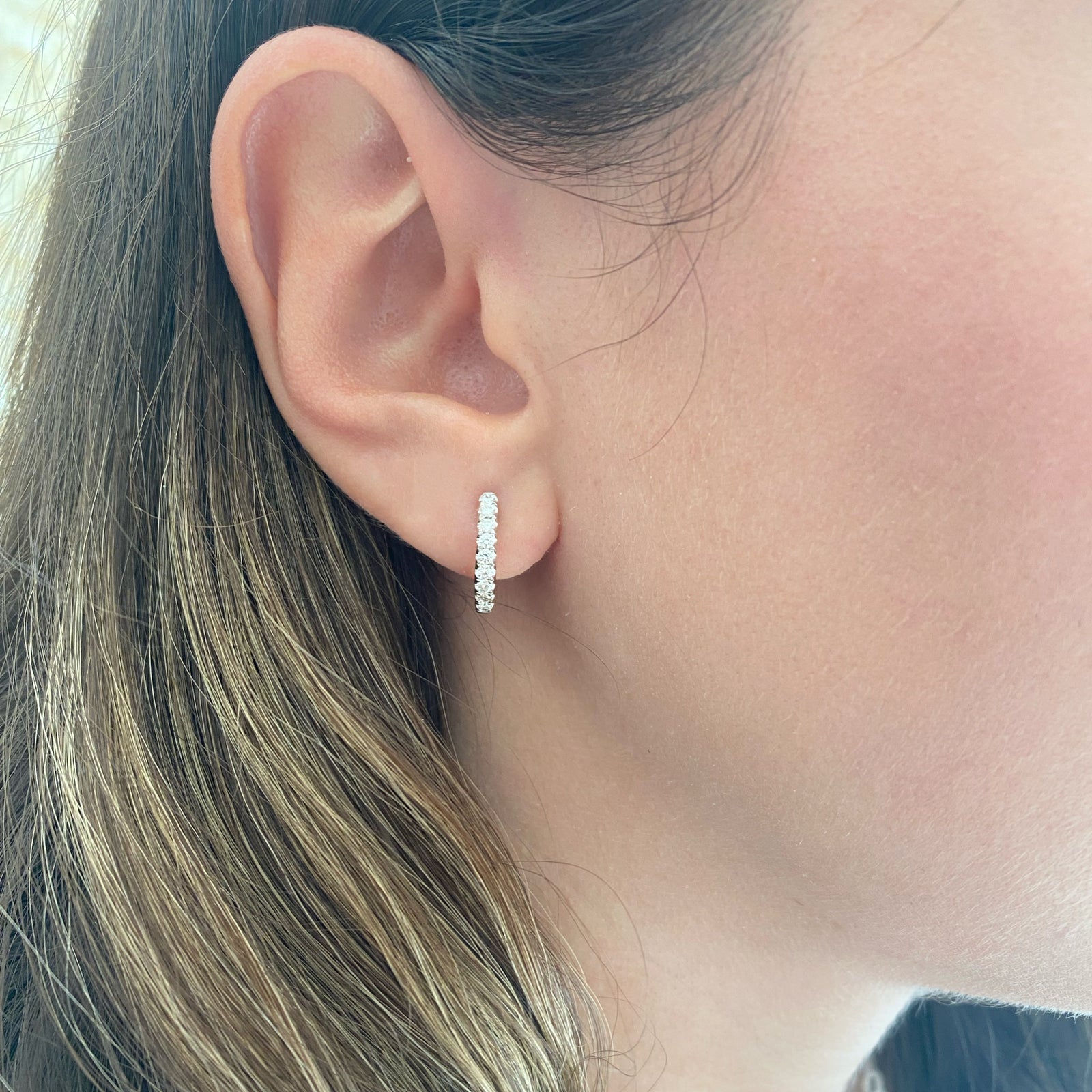 Solid 14K yellow gold weighing 2.77 grams featuring 18 round diamonds weighing 0.39 carats  0.39 ct Huggie Earrings | Nuha Jewelers