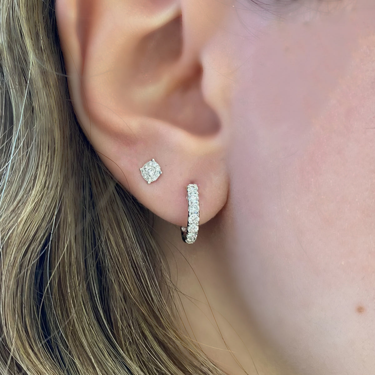 Female Model Wearing Solid 14K yellow gold weighing 2.77 grams featuring 18 round diamonds weighing 0.39 carats 0.39 ct Huggie Earrings | Nuha Jewelers