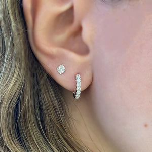 Female Model Wearing Solid 14K yellow gold weighing 2.77 grams featuring 18 round diamonds weighing 0.39 carats 0.39 ct Huggie Earrings | Nuha Jewelers