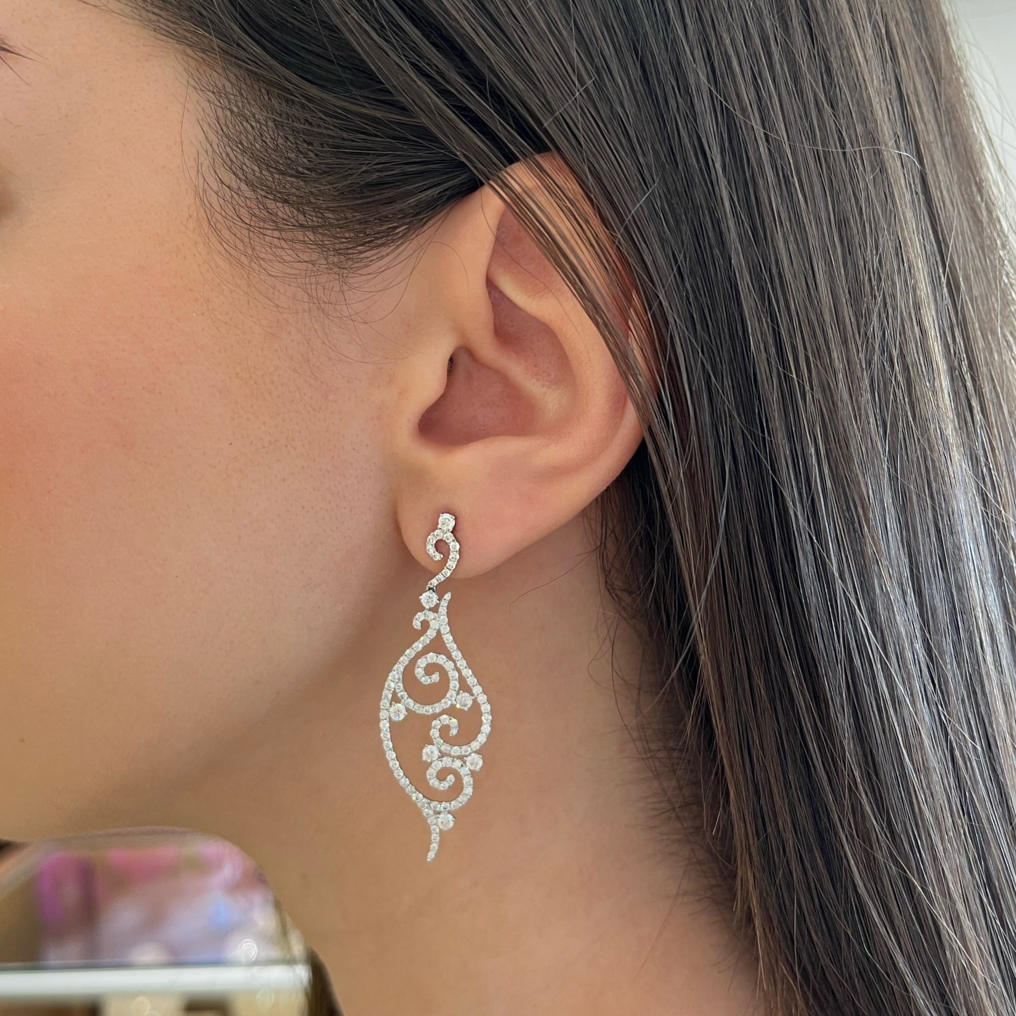 Diamond Swirl Earrings  18k gold, 6.88 grams, 14 round prong-set diamonds .8 carats, 200 round shared prong-set diamonds 2.22 carats.