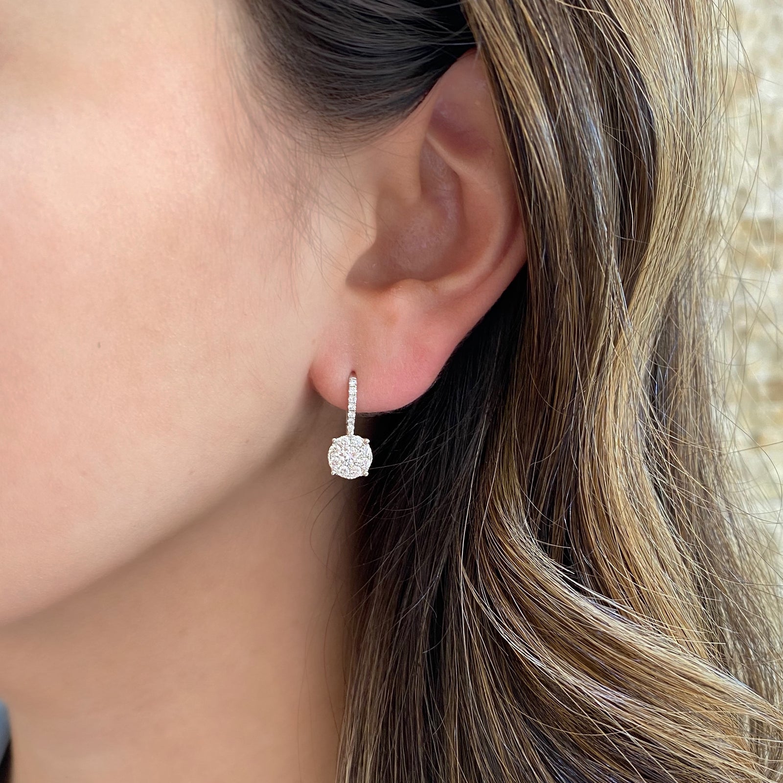 Diamond Round Halo Lever-Back Earrings  -18K gold weighing 2.52 grams  -2 round diamonds totaling 0.34 carats  -30 round diamonds totaling 0.55 carats