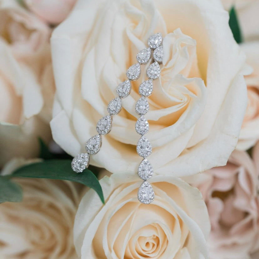 Diamond Teardrop Long Dangle Earrings  - 18K gold weighing 8.24 grams  - 192 round diamonds totaling 1.05 carats  - 16 pear-shaped diamonds totaling 1.85 carats