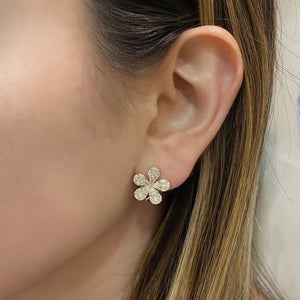 Female model wearing Diamond daisy stud earrings 18k gold, 5.93 grams, 10 pear shape prong-set diamonds .88 carats, 10 princess prong-set diamonds .27 carats, 30 marquise prong-set diamonds .84 carats.