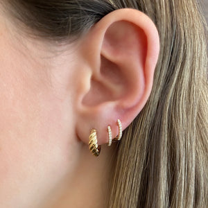 Female Model Wearing Gold Cable Huggie Earrings - 14K gold weighing 3.05 grams