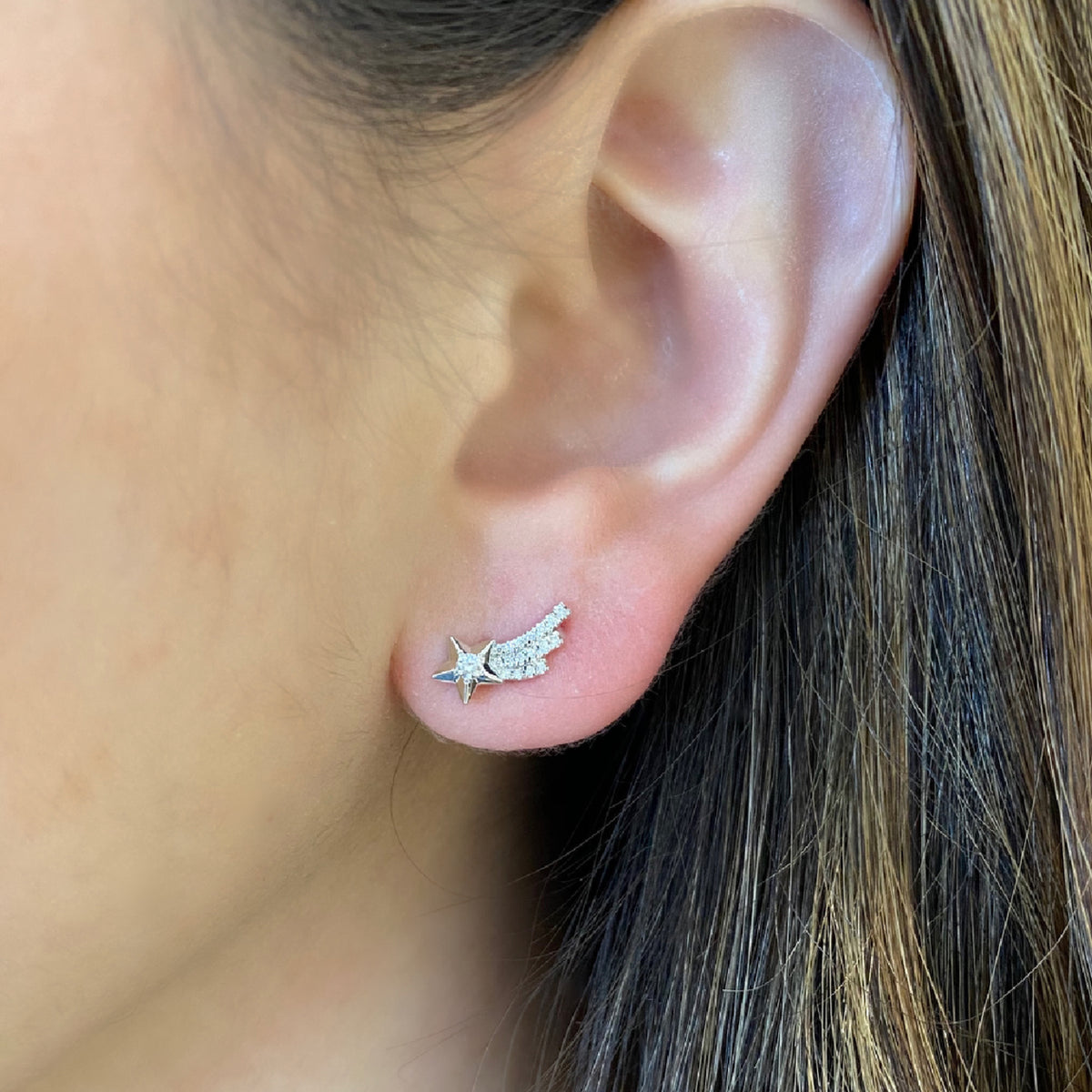 Female model wearing Celestial Diamond Stud Earrings -14K gold weighing 1.39 grams -27 round diamonds weighing 0.18 carats