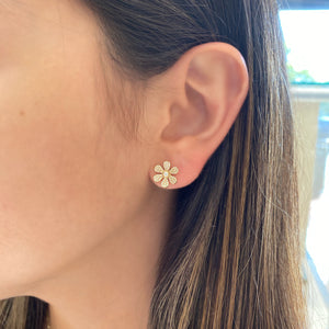female model wearing Diamond medium daisy stud earrings - 14K gold weighting 2.21 grams. - 158 round diamonds totaling 0.37 carats.