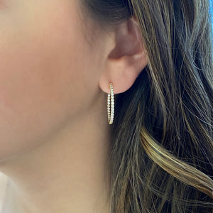 Female model wearing Diamond hoop earrings 1 inch size 14k Gold, 4.40 grams, 66 round prong set diamonds .97 carats.  Earring size 1 inch diameter.