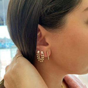 Female Model Wearing V-Shaped Diamond Huggie Earrings -14k gold weighing 2.09 grams  -56 round diamonds weighing .16 carats