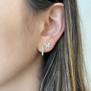 Female model wearing Mini Diamond Butterfly Stud Earrings -14kt gold weighing 1.49 grams -68 round pave set diamonds weighing .17 carats