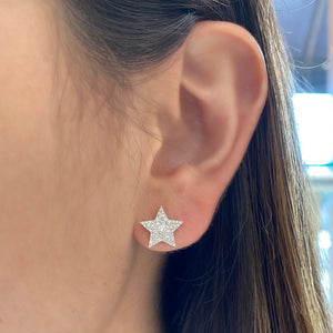 Female model wearing Star Stud Earrings -14k Gold weighing 2.09 grams -112 round pave set diamonds 0.32 carats.