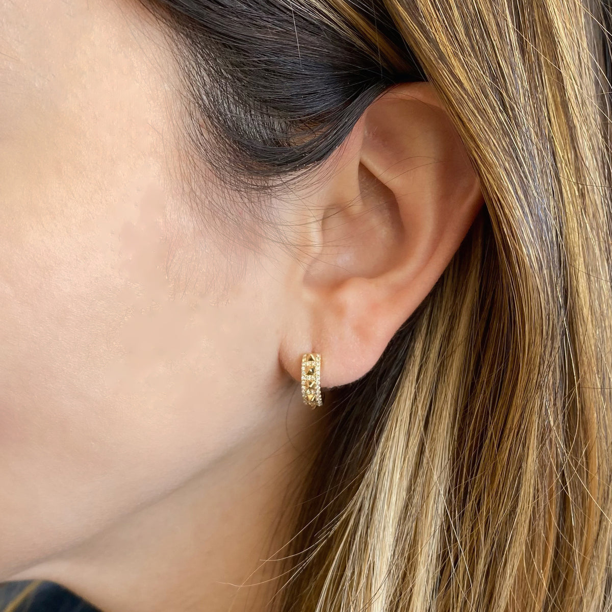 Female Model Wearing Diamond & Gold Pyramid Stud Huggie Earrings - 14K gold weighing 2.98 grams  - 72 round diamonds totaling 0.18 carats