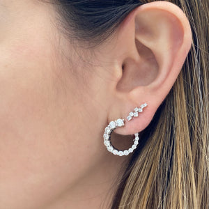 Female model wearing Scattered Diamond Earrings - 14k gold weighing 1.64 grams - 14 round prong-set diamonds weighing 0.33 carats