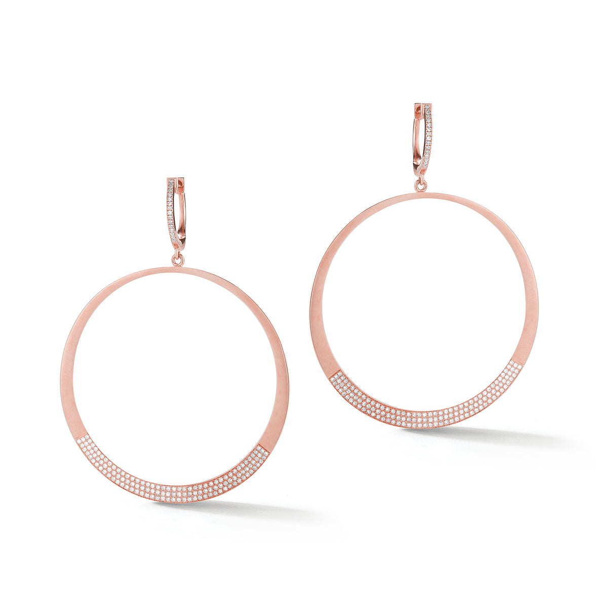 Circle Statement Earrings  These partial diamond hoops are composed of 14k gold, 9.66 grams, 284 round pave-set diamonds weighing .64 carats, making for a glamourous statement piece to amplify any look.