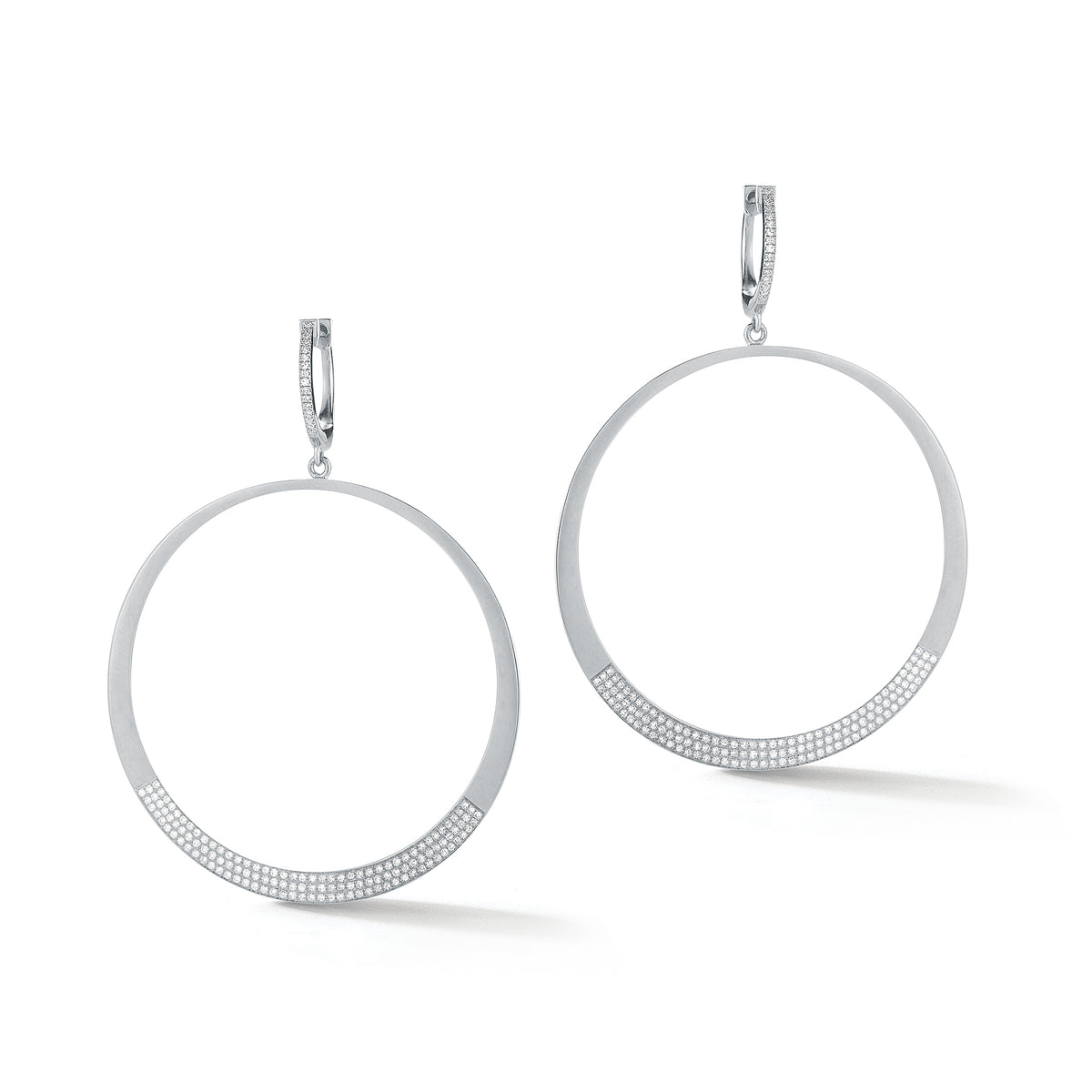 Circle Statement Earrings  These partial diamond hoops are composed of 14k gold, 9.66 grams, 284 round pave-set diamonds weighing .64 carats, making for a glamourous statement piece to amplify any look.