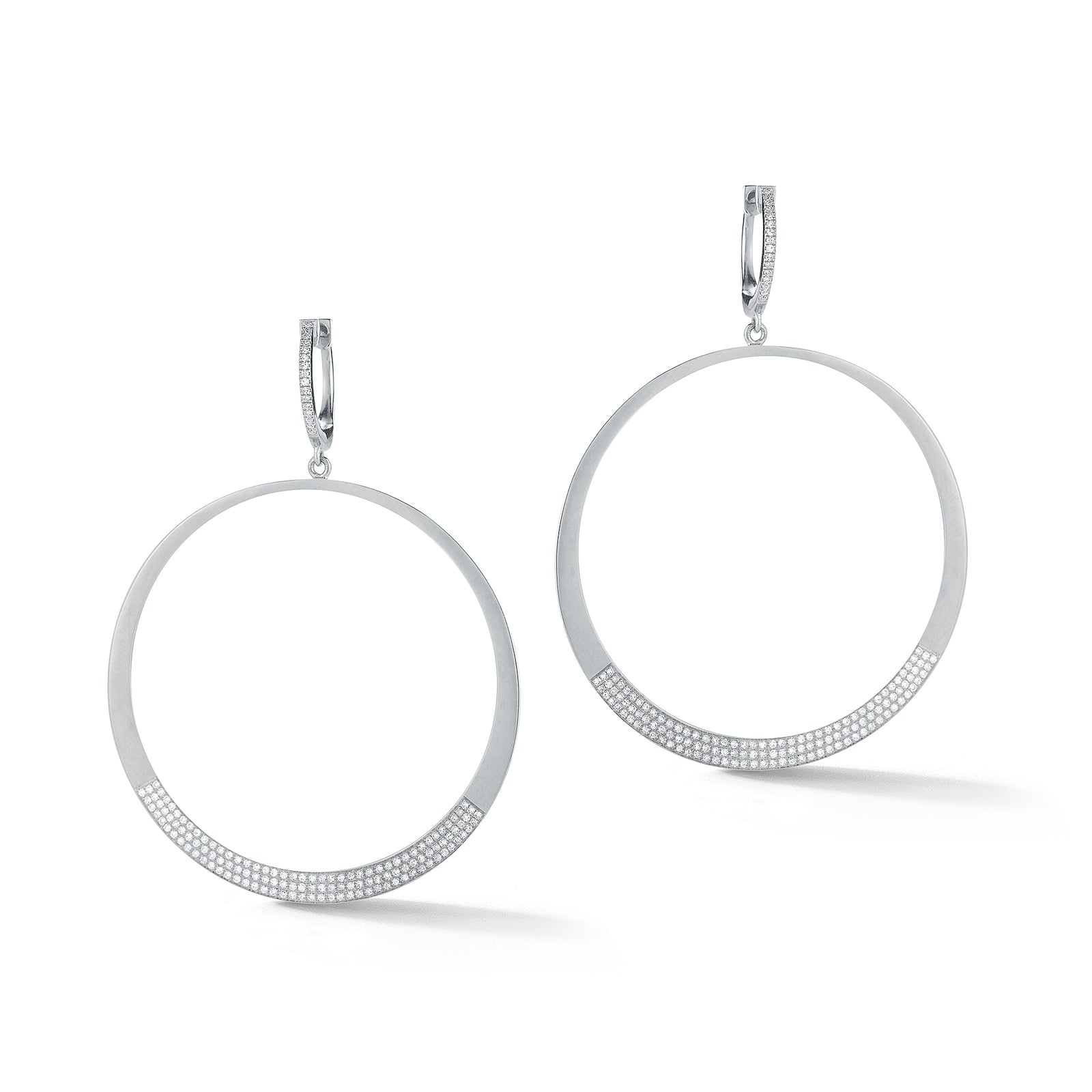 Circle Statement Earrings  These partial diamond hoops are composed of 14k gold, 9.66 grams, 284 round pave-set diamonds weighing .64 carats, making for a glamourous statement piece to amplify any look.