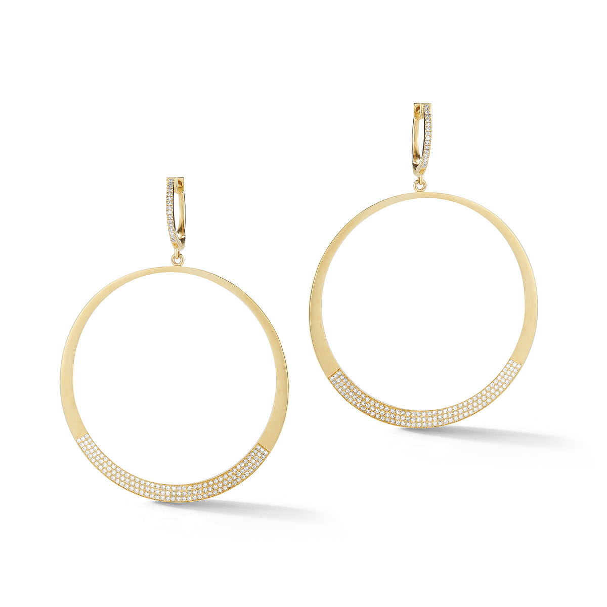 Circle Statement Earrings  These partial diamond hoops are composed of 14k gold, 9.66 grams, 284 round pave-set diamonds weighing .64 carats, making for a glamourous statement piece to amplify any look.