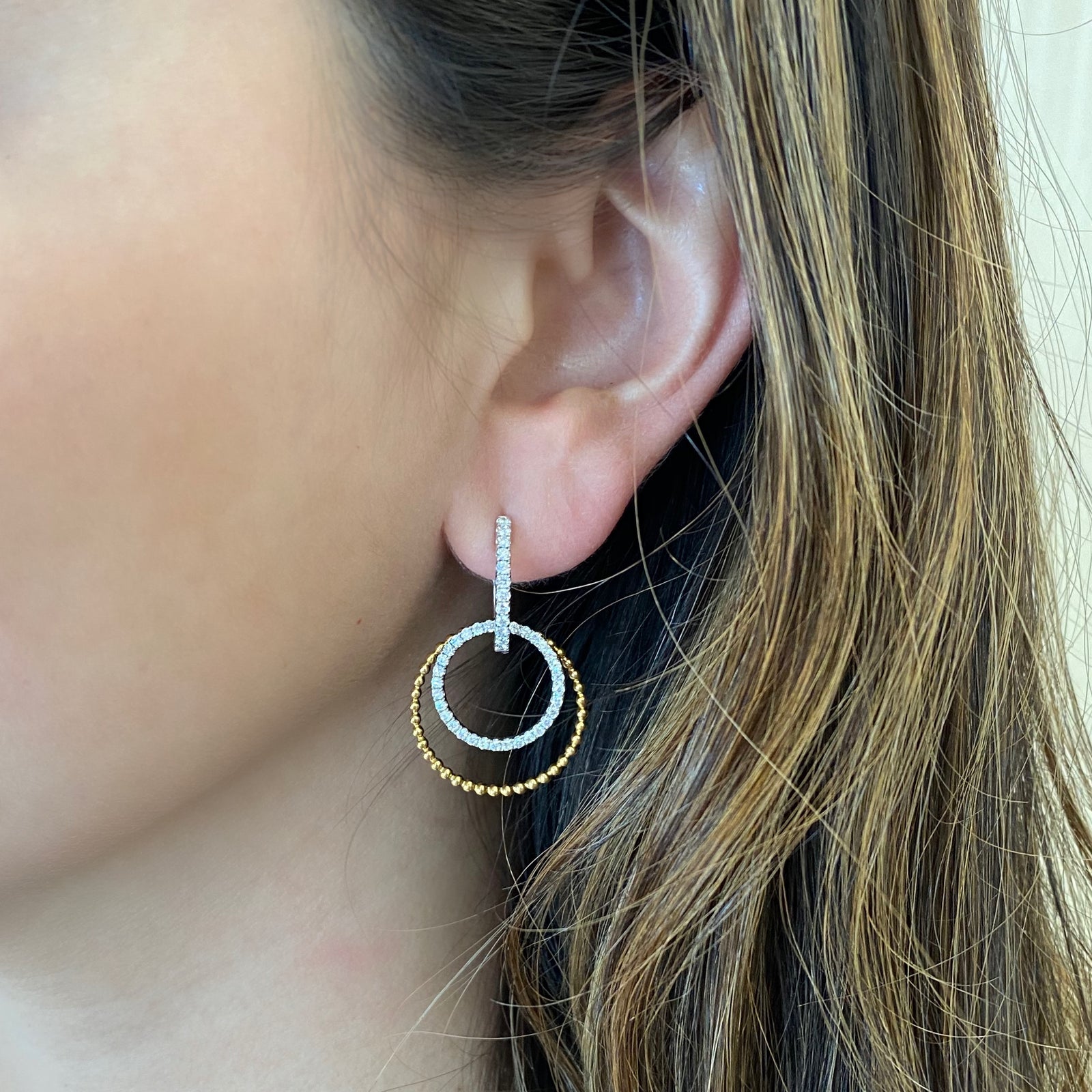 Diamond two-tone double hoop drop earrings -18K gold weighing 6.96 grams  -86 round shared prong-set diamonds totaling 0.94 carats.