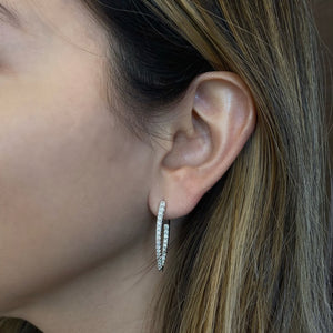 Female Model Wearing Diamond Interior Exterior Hoop Earrings - 18K gold weighing 6.53 grams  - 52 round diamonds totaling 1.21 carats