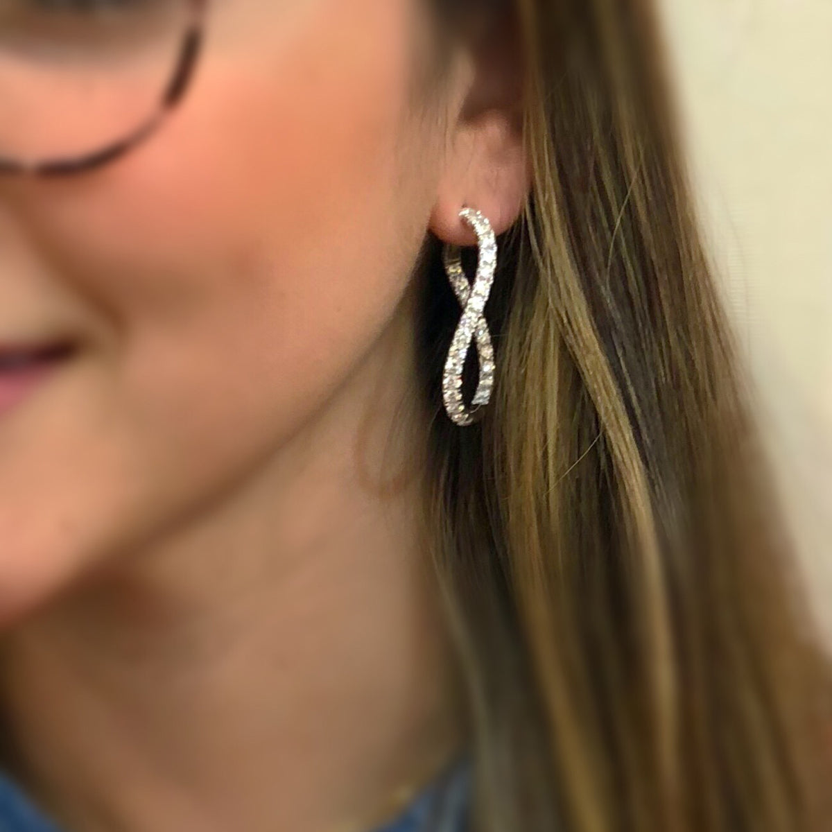 Female model wearing Thick luxe diamond twisted hoops earrings -18K gold weighing 13.06 grams  -56 round diamonds totaling 4.74 carats