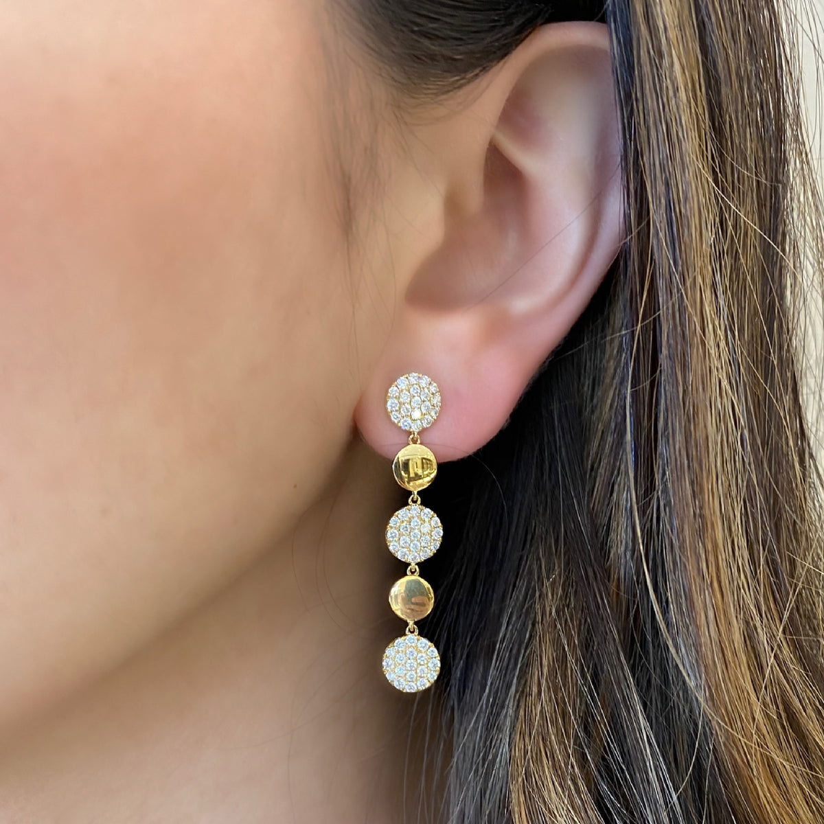 Female Model Wearing Pave Diamond Disc Dangle Earrings  -18K gold weighing 5.20 grams  -114 round pave-set diamonds totaling 1.46 carats