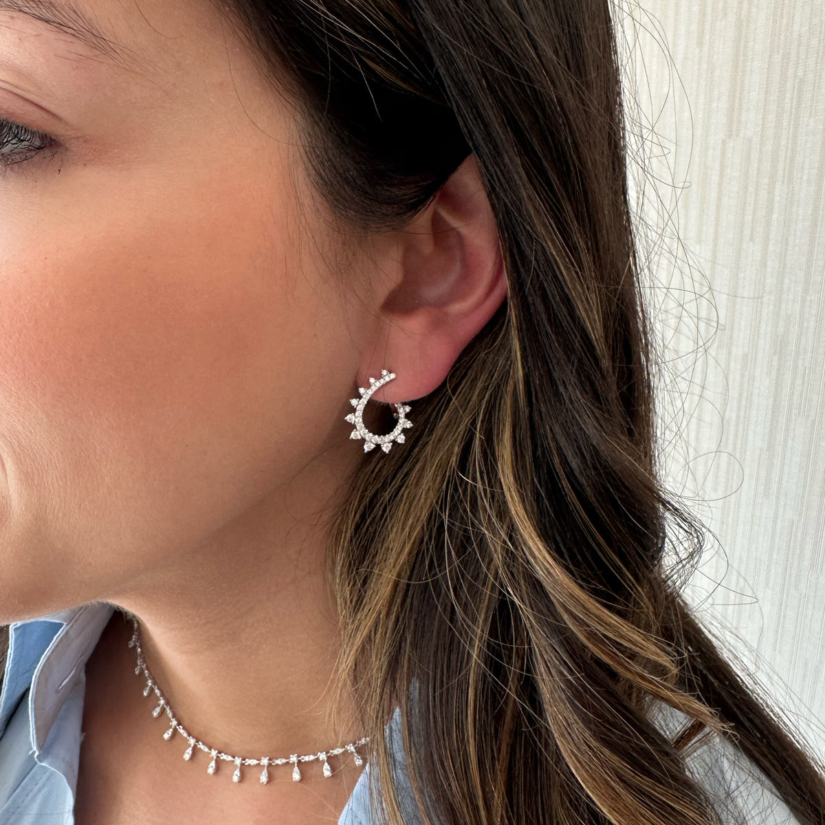 Female Model Wearing Diamond Intricate Swirl Front-Facing Earrings - 18K gold weighing 4.03 grams  - 72 round diamonds weighing 0.94 carats