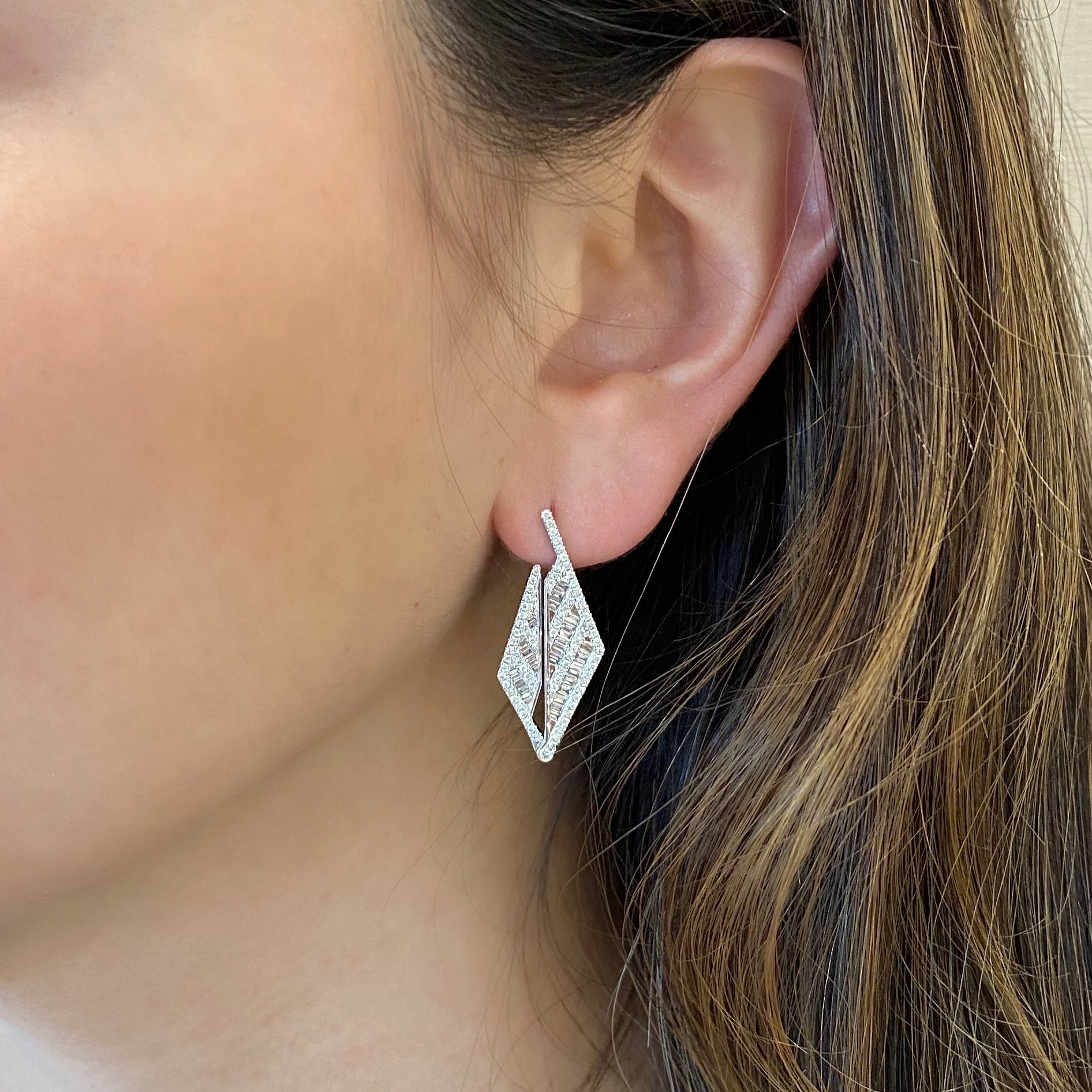 Diamond Triangle Drop Earrings  -18K gold weighing 7.87 grams  -148 round diamonds totaling 0.52 carats  -58 straight baguettes totaling 0.52 carats